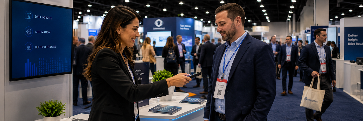 An exhibitor scanning an attendee's name badge with a handheld lead retrieval scanner on a trade show floor